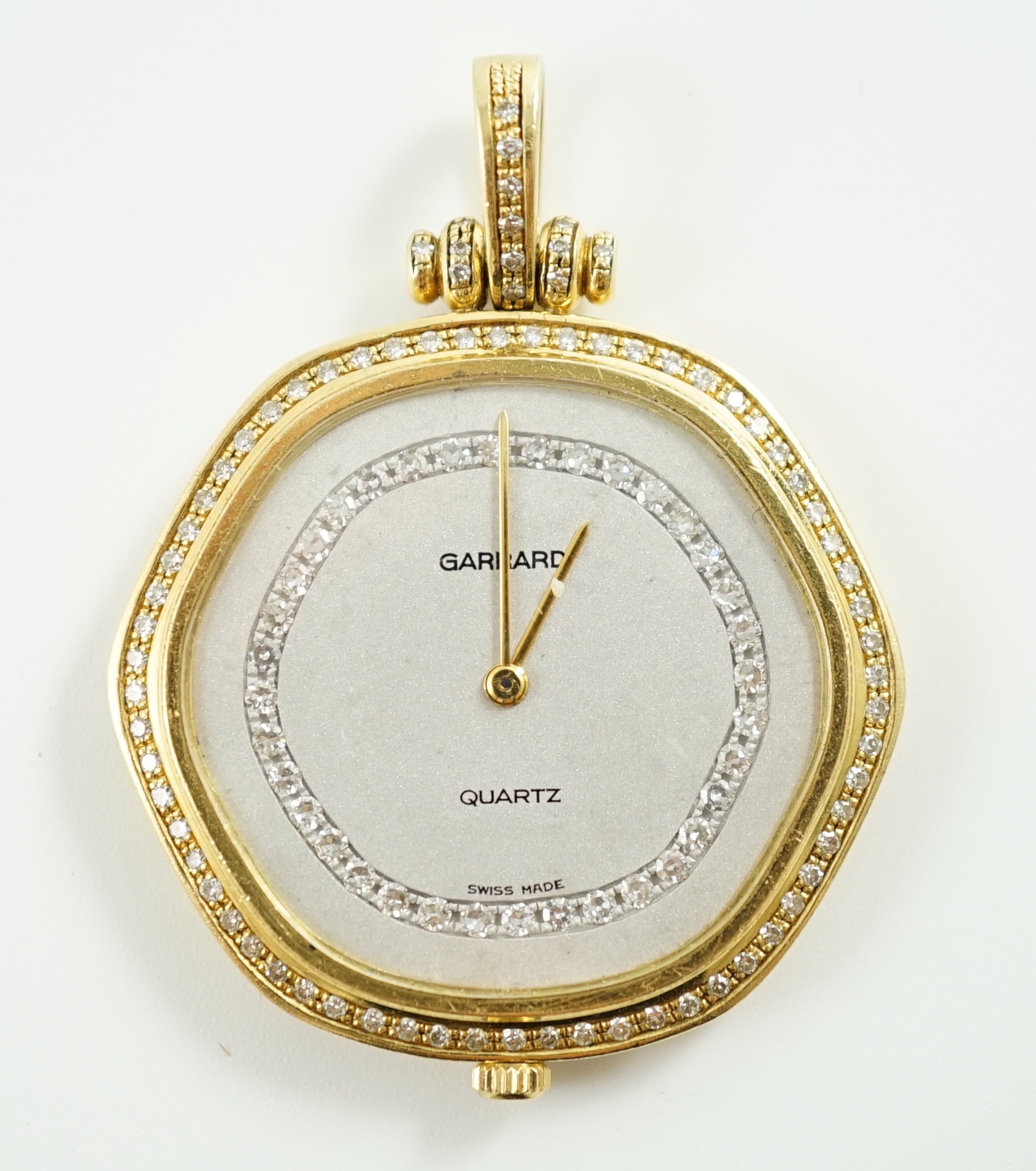 A modern 18ct gold and diamond set quartz shaped hexagonal pendant dress watch, retailed by Garrard